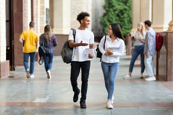 Students walking and talking together on campus during a break